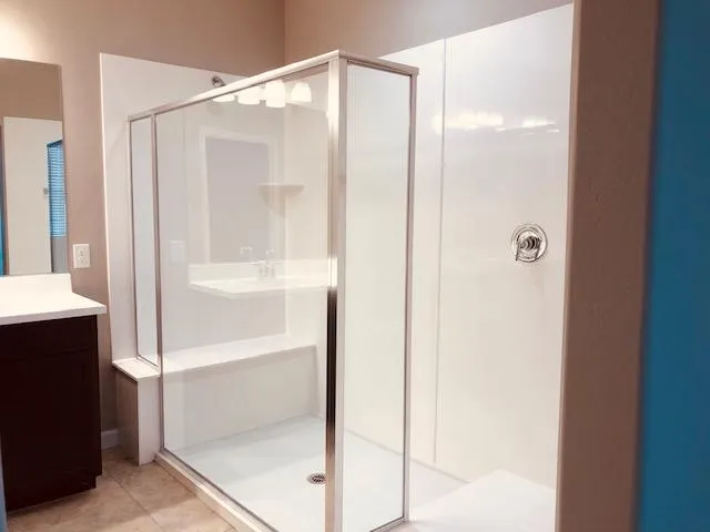 a bathroom with a glass shower door