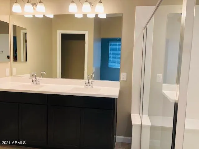 a bathroom with a sink double vanity and a mirror