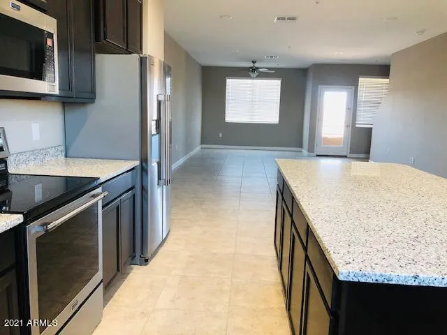 a kitchen with stainless steel appliances granite countertop a sink and a stove