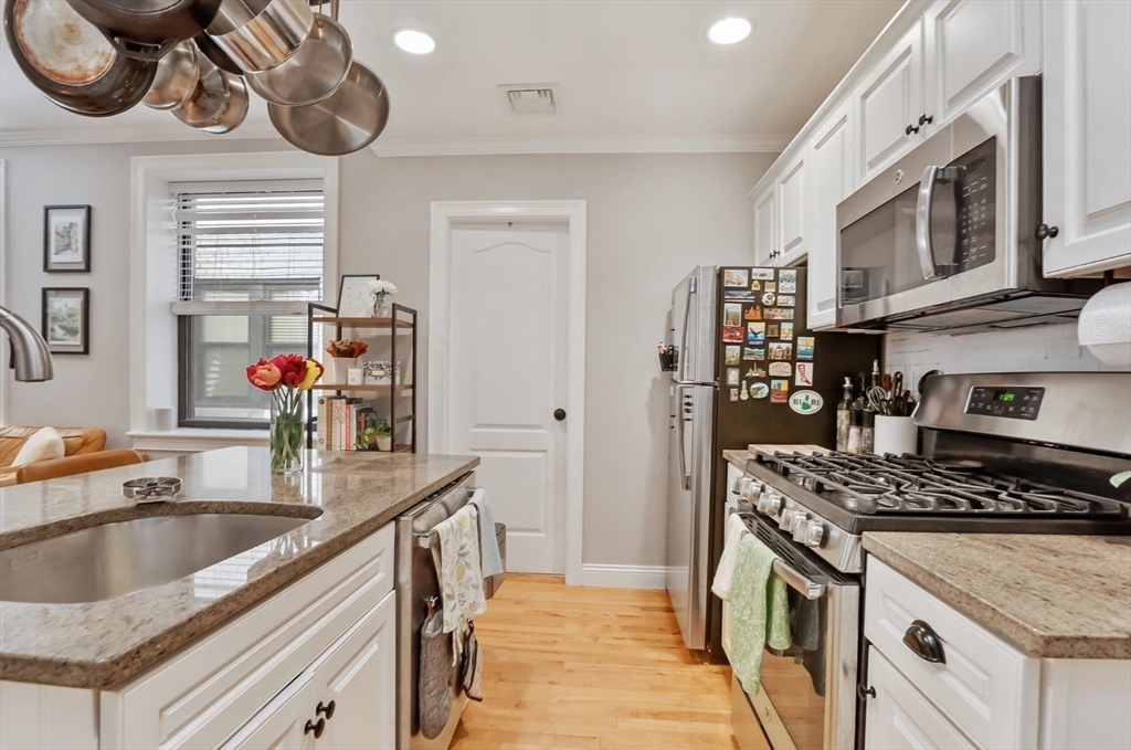 454 Hanover Street, Unit 4 Boston, MA 02113 - Photo 10 of 23 a kitchen that has a sink and a stove