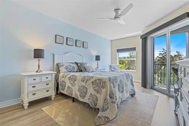 a bedroom with a large bed and a chandelier