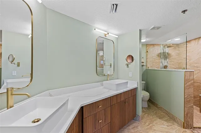 a bathroom with a tub sink and mirror