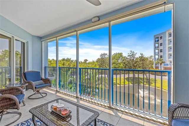 a living room with furniture and floor to ceiling windows