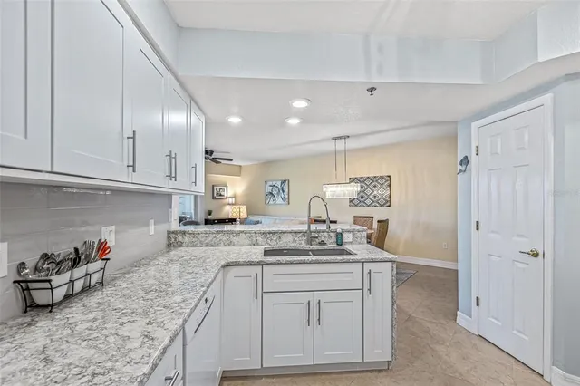 a kitchen with sink cabinets and stove top oven