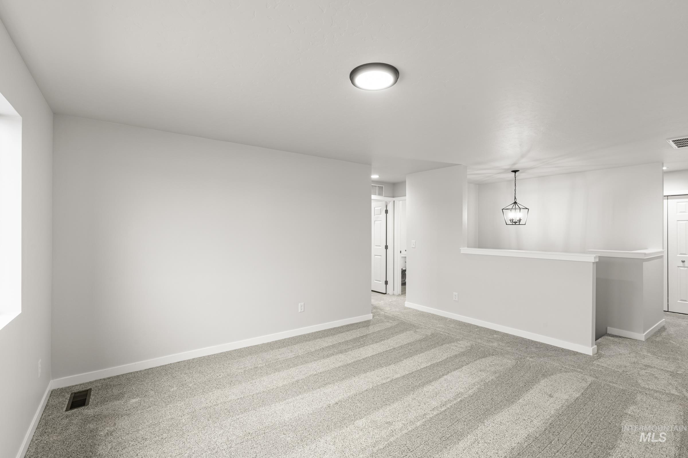 13693 Redway Court Caldwell, ID 83607 - Photo 14 of 25 Spare room featuring light carpet and baseboards
