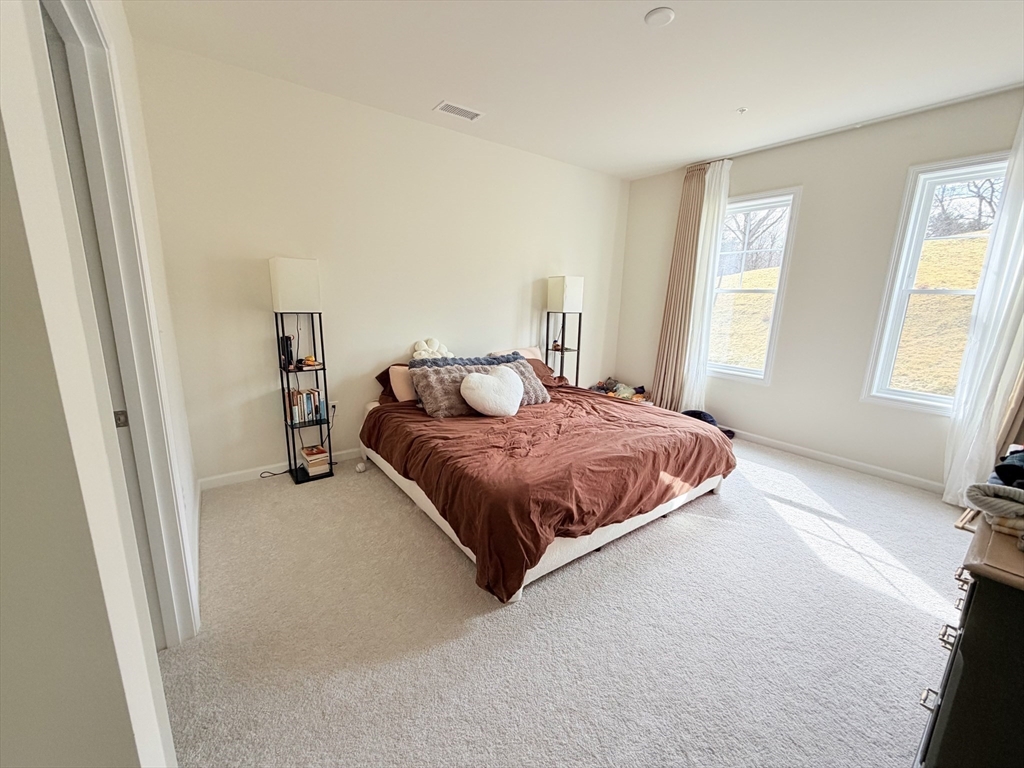 6 Stratton Drive, Unit 110 Woburn, MA 01801 - Photo 14 of 26 a bedroom with a bed and a window
