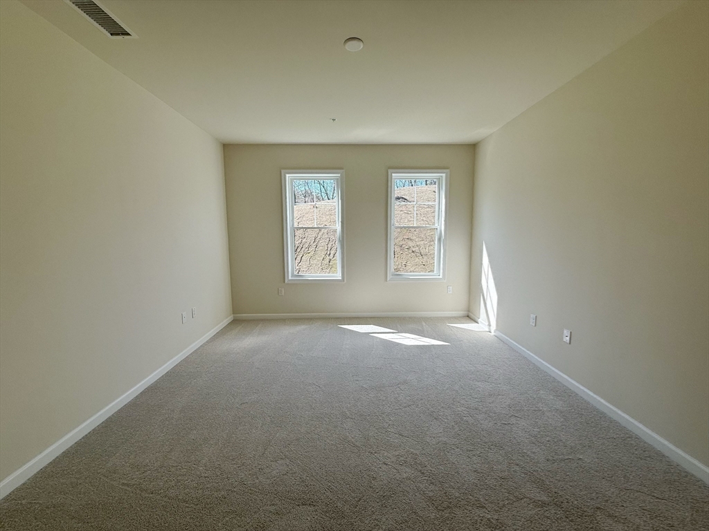 6 Stratton Drive, Unit 110 Woburn, MA 01801 - Photo 16 of 26 an empty room with windows