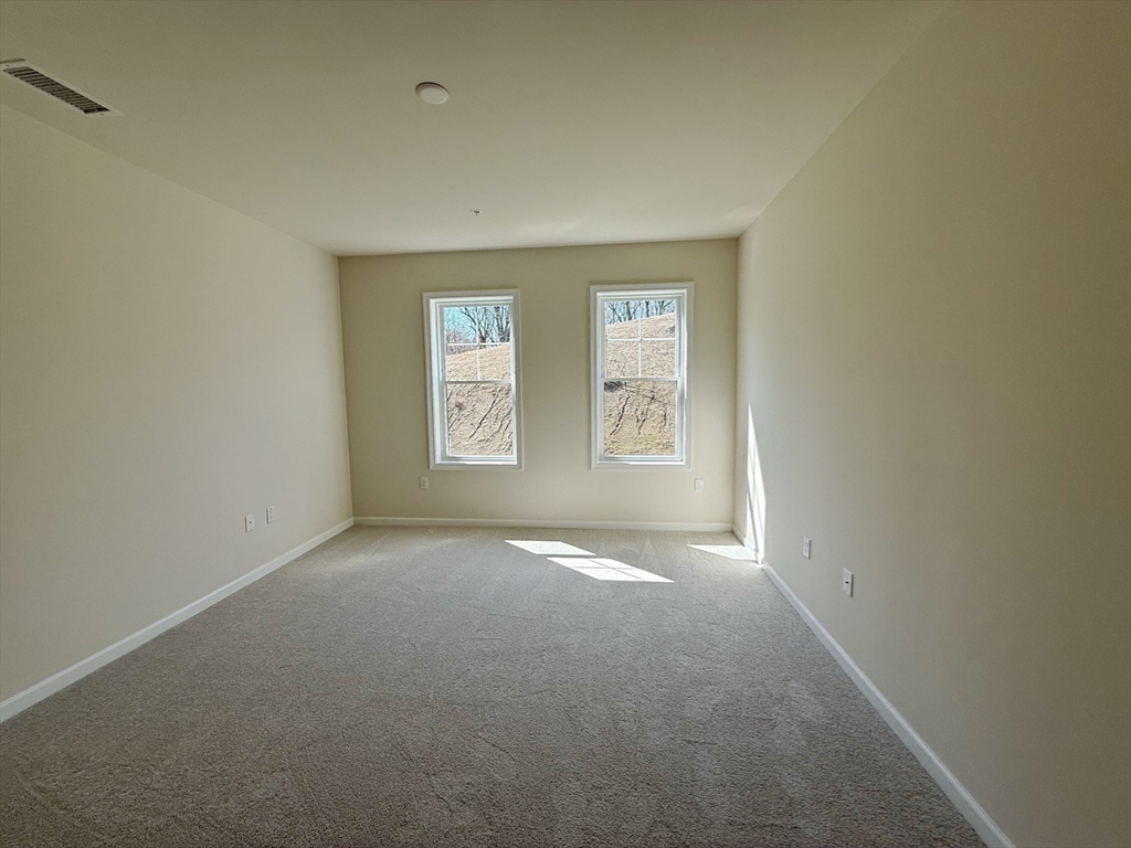 6 Stratton Drive, Unit 110 Woburn, MA 01801 - Photo 17 of 26 an empty room with windows