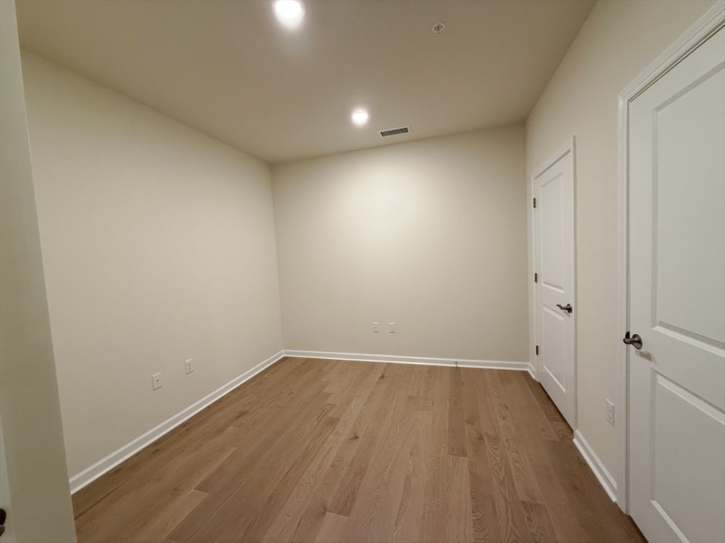 6 Stratton Drive, Unit 110 Woburn, MA 01801 - Photo 21 of 26 wooden floor in an empty room