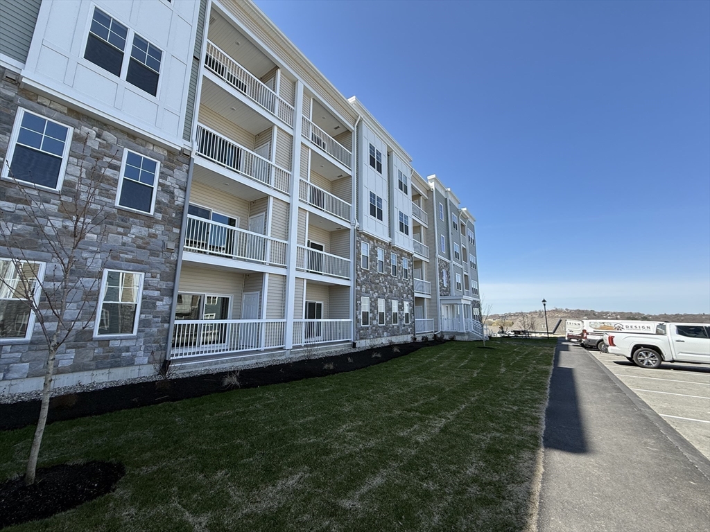 6 Stratton Drive, Unit 110 Woburn, MA 01801 - Photo 24 of 26 a view of an apartment with a backyard