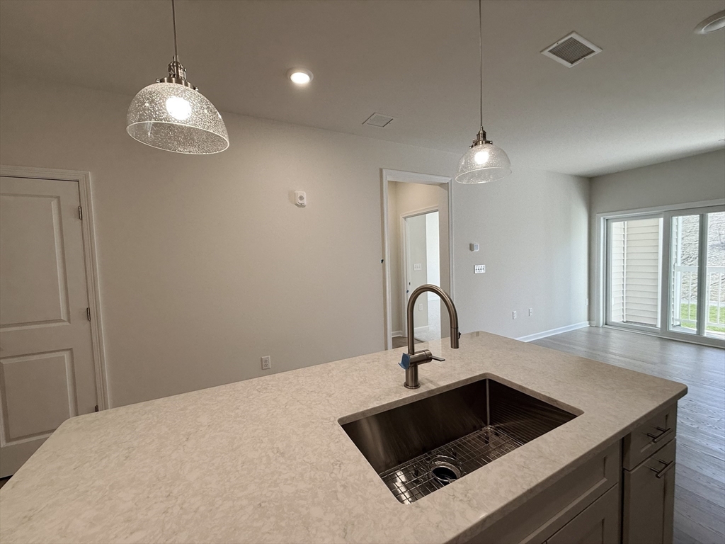 6 Stratton Drive, Unit 110 Woburn, MA 01801 - Photo 5 of 26 a kitchen with a sink and chandelier