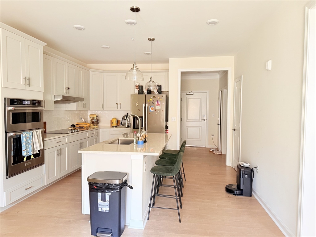 6 Stratton Drive, Unit 110 Woburn, MA 01801 - Photo 6 of 26 a view of kitchen with kitchen island and stainless steel appliances