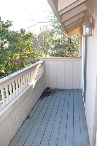 a view of a balcony with wooden floor