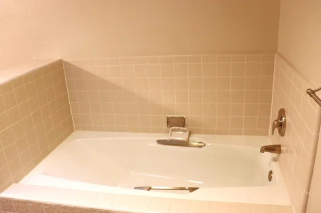 a view of a hallway with wooden floor and windows