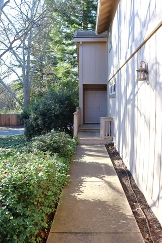 a view of a pathway of a house with a yard