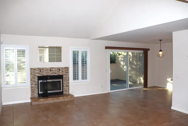 an empty room with furniture and a fireplace