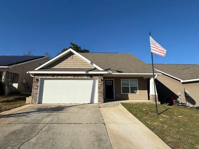 a view of a house with a yard and garage