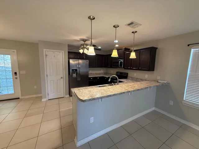 a view of a kitchen with a sink and a fireplace
