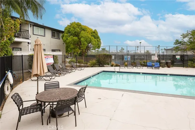 a view of a swimming pool with outdoor seating