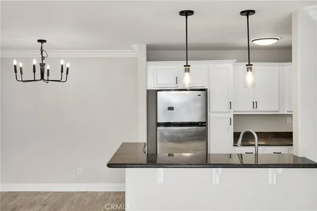 a kitchen with granite countertop a sink stainless steel appliances and cabinets
