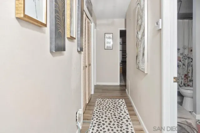 a bedroom with a bed and a painting on the wall
