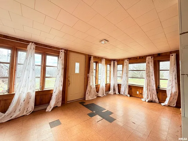 a living room with furniture and large windows