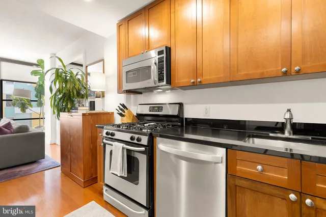 a kitchen with stainless steel appliances granite countertop a stove a sink and a microwave