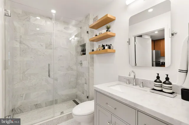 a bathroom with a sink a toilet and shower