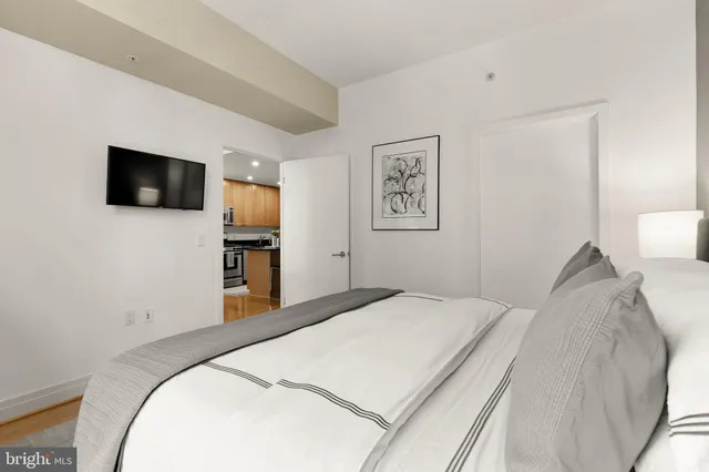 a bedroom with a bed and a flat screen tv