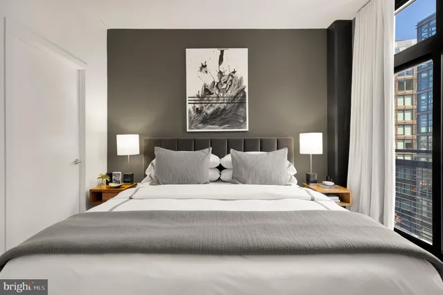 a bedroom with a large bed and a window