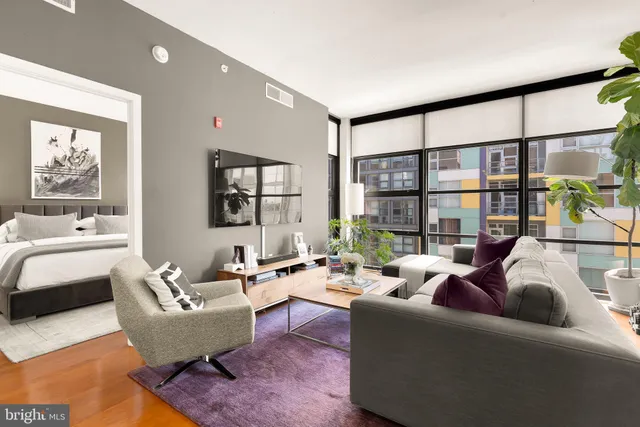 a living room with furniture and a large window