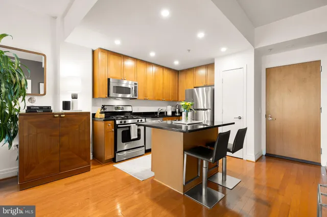 a kitchen with stainless steel appliances granite countertop a stove a sink dishwasher and a refrigerator