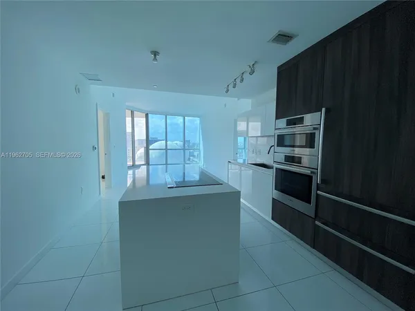 a bathroom with a sink a toilet a mirror and shower