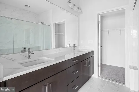 a bathroom with a double vanity sink and a mirror