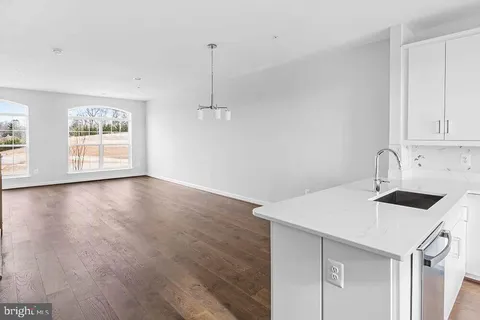 a view of a kitchen sink and microwave