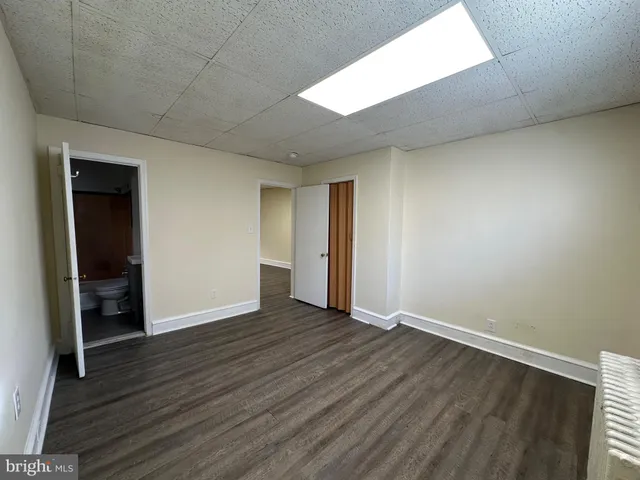 an empty room with wooden floor and closet