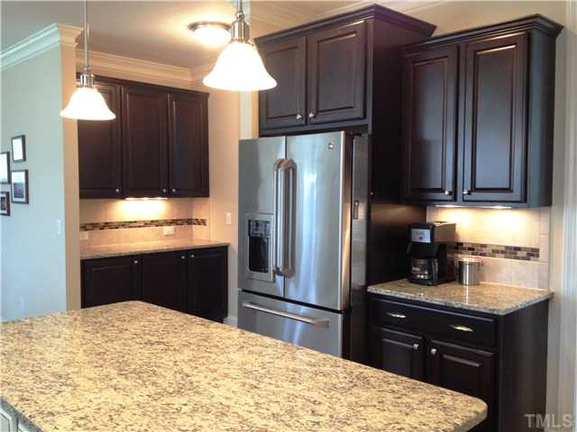 3614 Silver Forrest Lane Raleigh, NC 27614 - Photo 8 of 25 Another view of the spacious kitchen showing the butler's pantry. The kitchen is well lit with recessed lights in the ceiling and pendants over the island. Kitchen