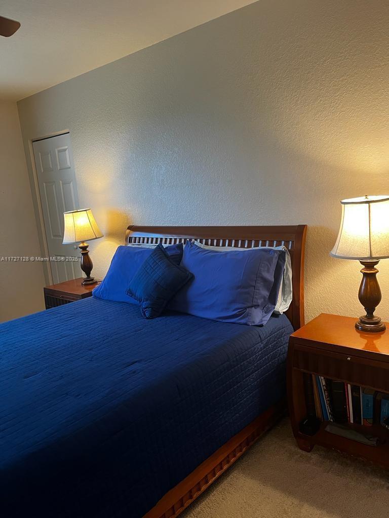 5923 Abbey Road Tamarac, FL 33321 - Photo 15 of 37 a bedroom with a bed and lamps