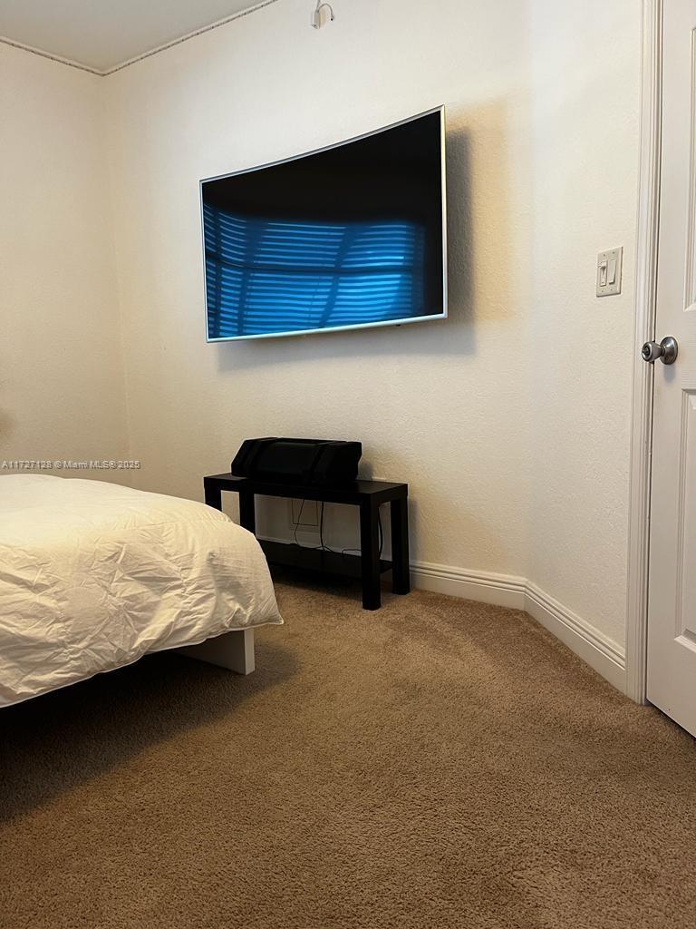 5923 Abbey Road Tamarac, FL 33321 - Photo 19 of 37 a bedroom with a bed and a television