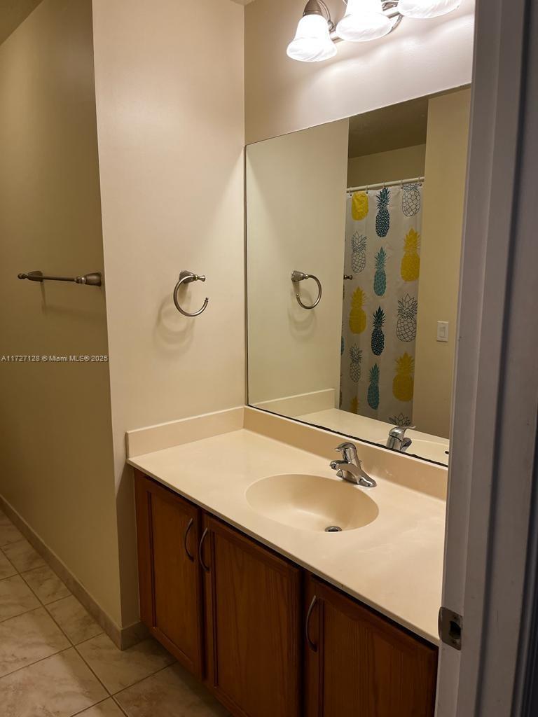 5923 Abbey Road Tamarac, FL 33321 - Photo 22 of 37 a bathroom with a sink and a mirror