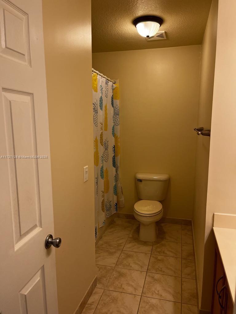 5923 Abbey Road Tamarac, FL 33321 - Photo 23 of 37 a bathroom with a toilet and a shower