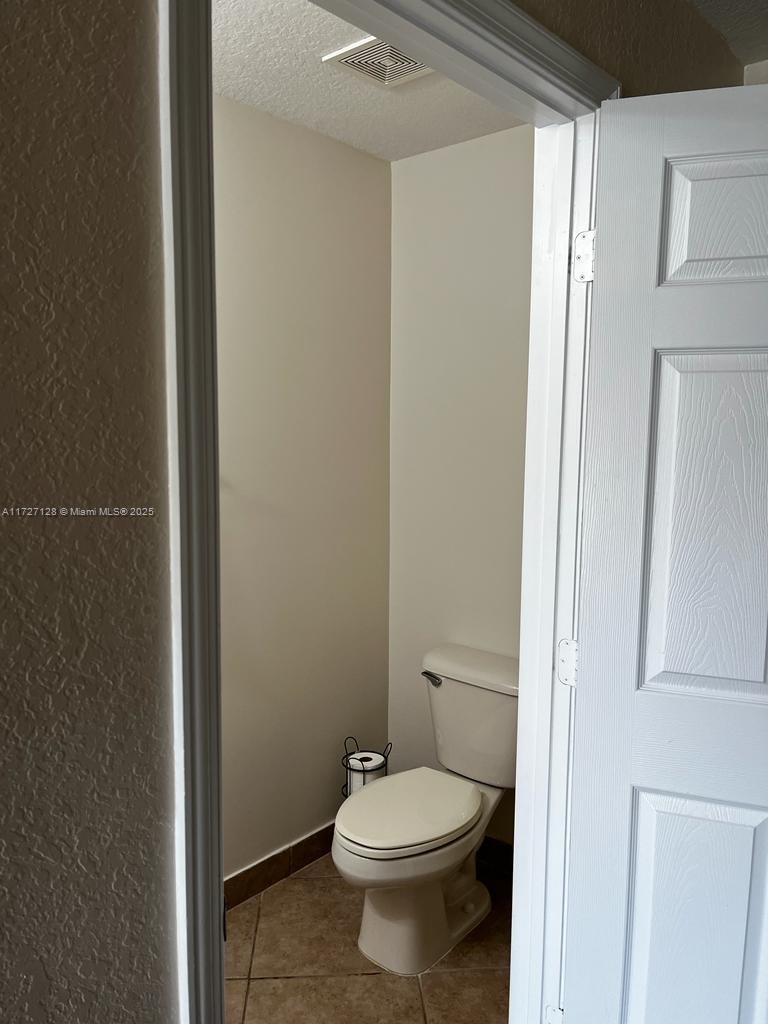 5923 Abbey Road Tamarac, FL 33321 - Photo 24 of 37 a white toilet sitting next to a bathroom sink