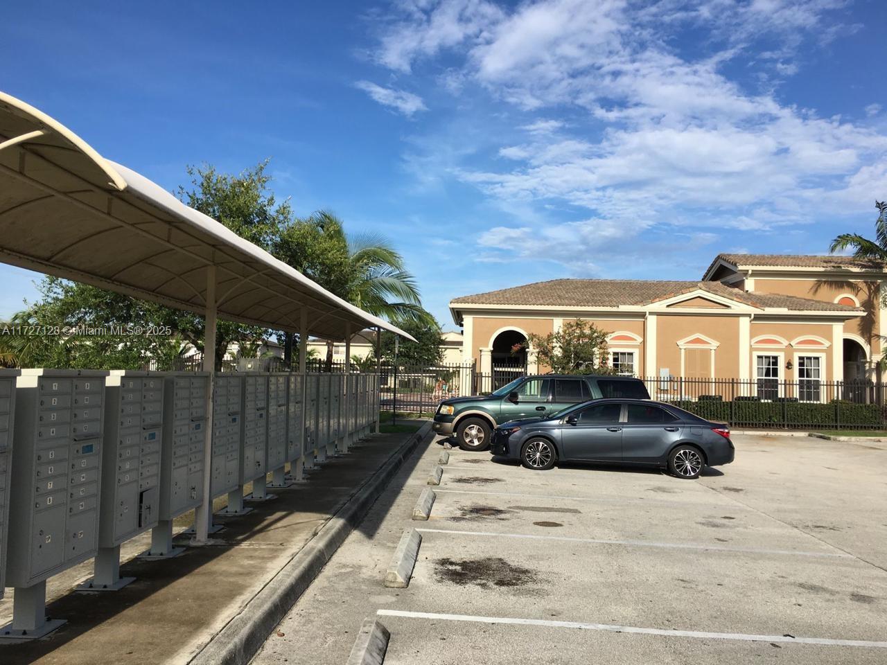 5923 Abbey Road Tamarac, FL 33321 - Photo 30 of 37 a front view of a house with cars parked