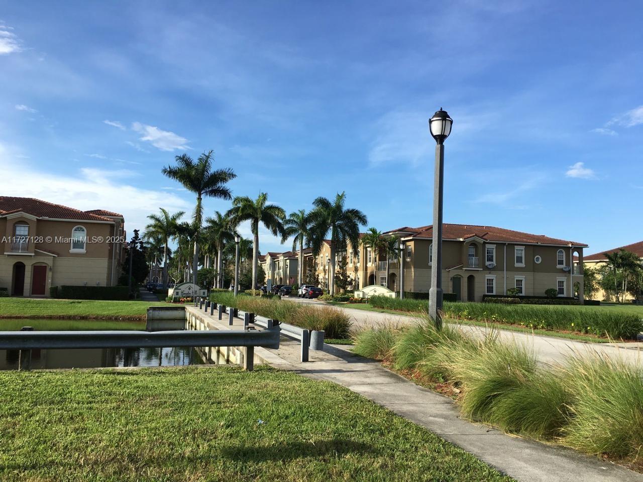 5923 Abbey Road Tamarac, FL 33321 - Photo 34 of 37 a view of a bench in front of a house