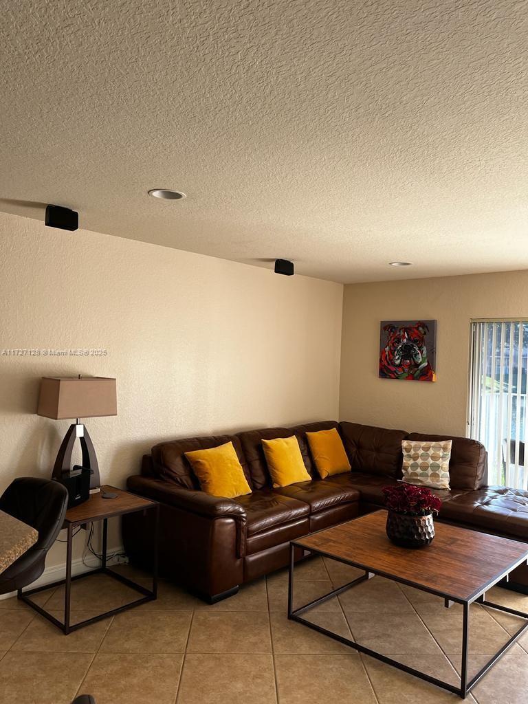 5923 Abbey Road Tamarac, FL 33321 - Photo 4 of 37 a living room with a couch and a coffee table