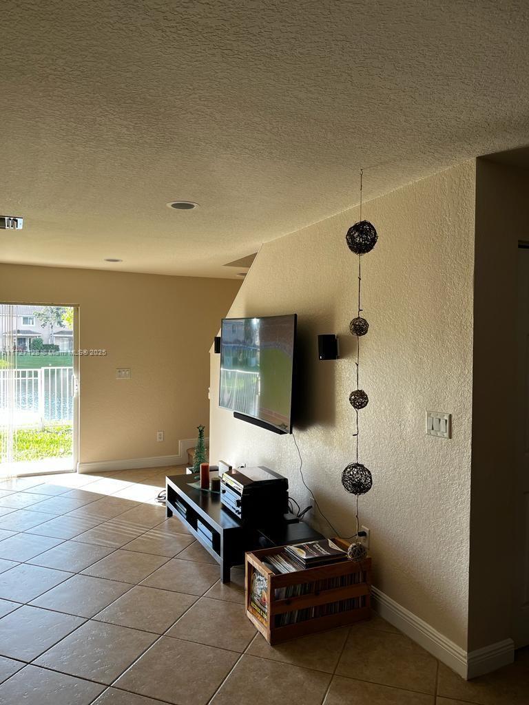 5923 Abbey Road Tamarac, FL 33321 - Photo 5 of 37 a living room with furniture and a flat screen tv