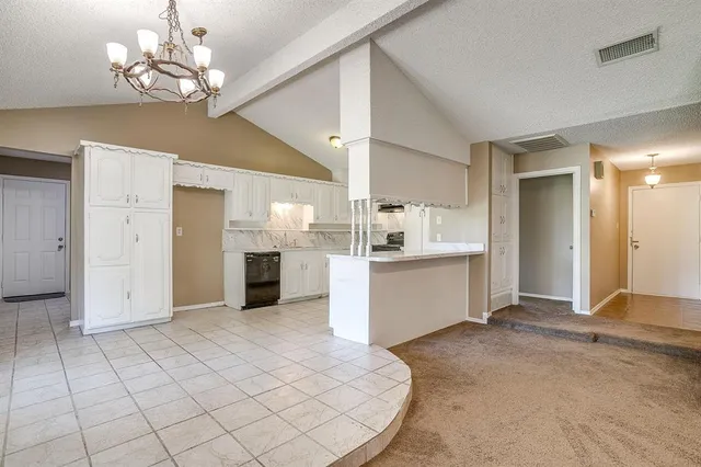 a view of a kitchen with a sink and chandelier