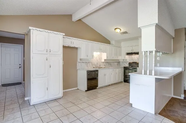 a kitchen with white cabinets and white appliances