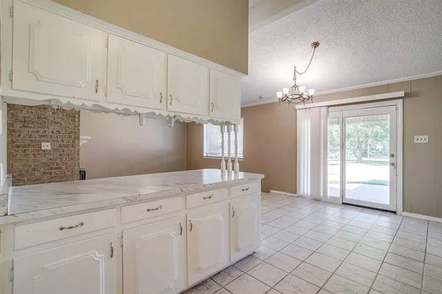 a view of a kitchen with furniture and chandelier