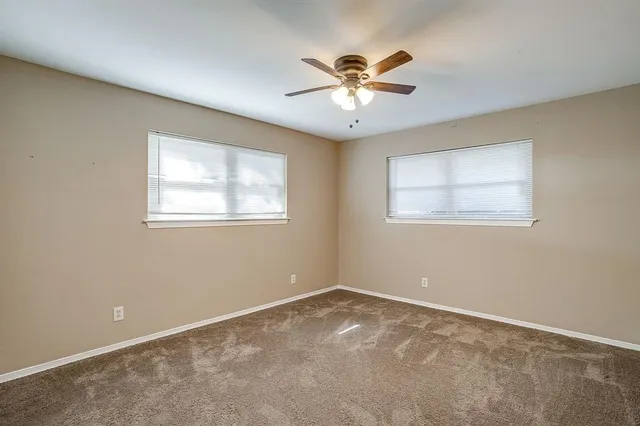 a view of room with a ceiling fan and window